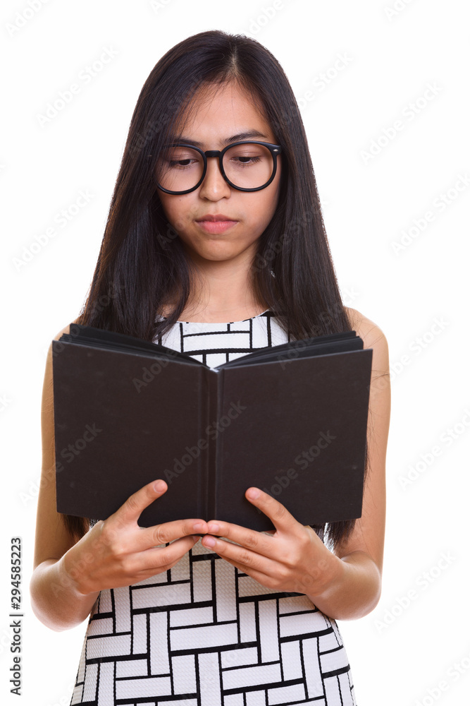 Close up of young Asian teenage nerd girl reading book Close up of young Asian teenage nerd girl reading book