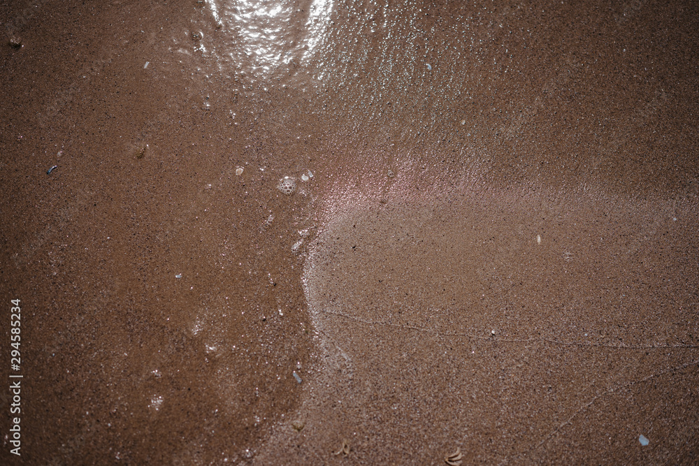 sea ​​water washes sand on the shore, top view