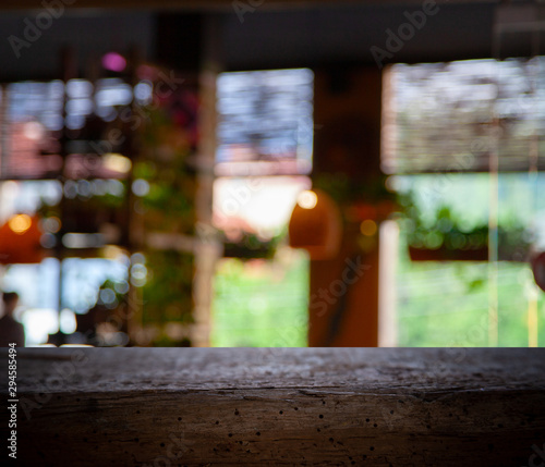 Blurred cafe restaurant club background with wooden table. Place under the text. Empty place. Interer cafe. © Egor
