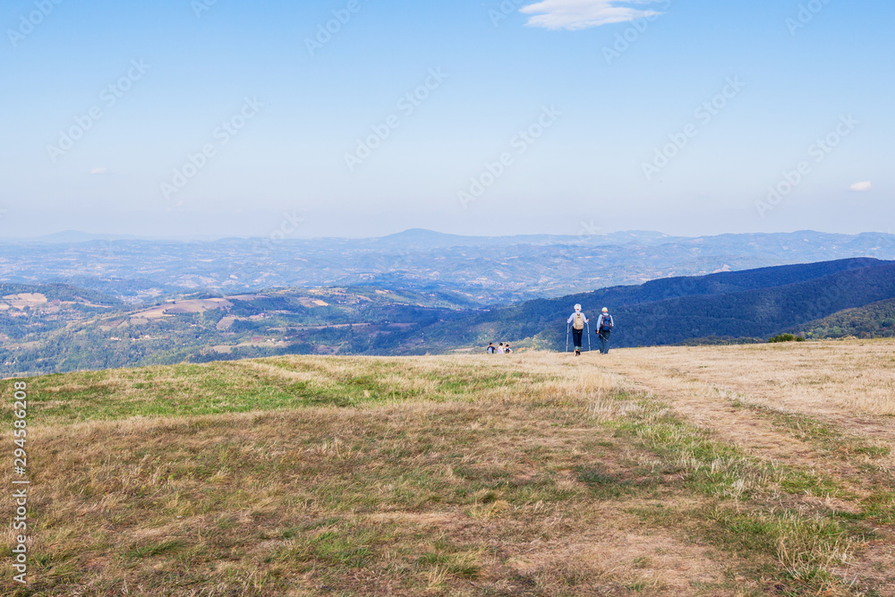 Senior hikers walking at beautiful mountains