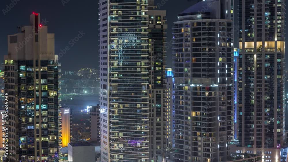 View of various skyscrapers and towers in Dubai Marina from above aerial night timelapse. Illuminated modern buildings in urban skyline View of various skyscrapers and towers in Dubai Marina from above aerial night timelapse. Illuminated modern buildings in urban skyline