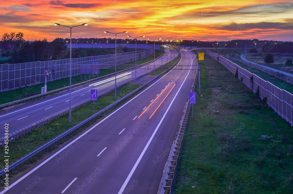 Highway at night. Beautiful colorful sky with the setting light over the A1 highway in Poland. Highway at night. Beautiful colorful sky with the setting light over the A1 highway in Poland.