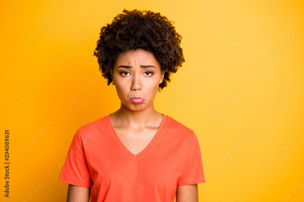Photo of sullen dark skin lady offended after boyfriend rude behavior wear orange v neck t-shirt isolated yellow color background Photo of sullen dark skin lady offended after boyfriend rude behavior wear orange v neck t-shirt isolated yellow color background