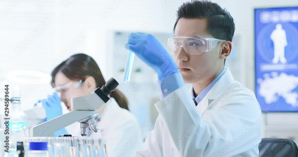 Asian scientist take test tube Asian scientist take test tube