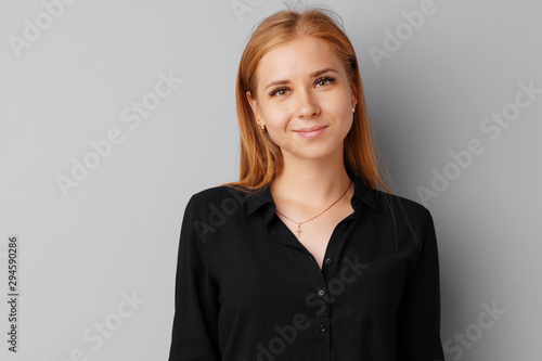 Beautiful young woman teenager posing over a grey background