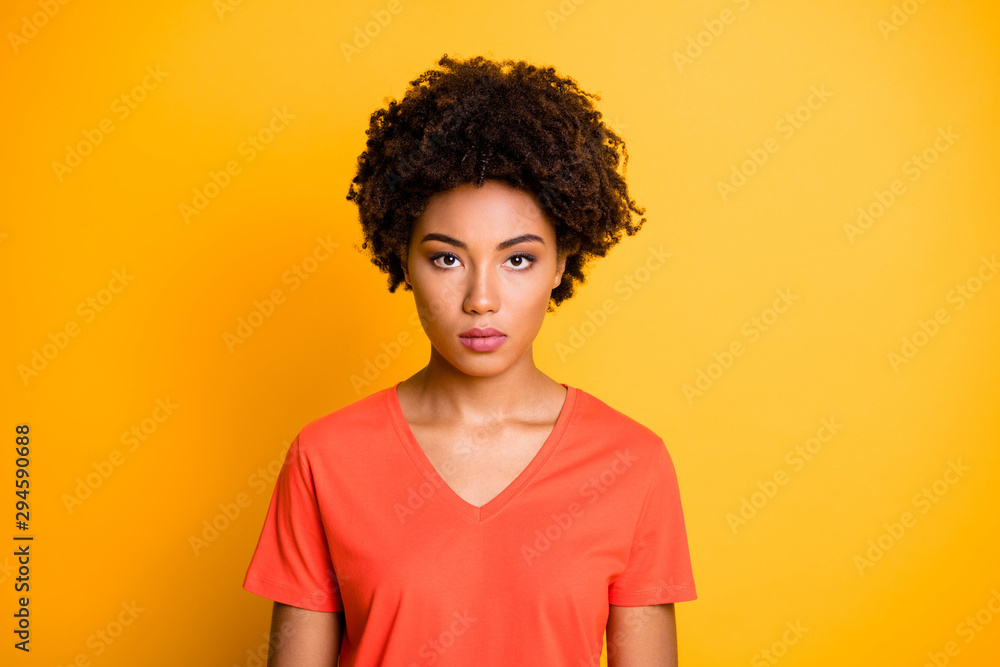 Photo of sweet lovely confident serious girlfriend staring into camera candidly isolated over yellow vivid color background Photo of sweet lovely confident serious girlfriend staring into camera candidly isolated over yellow vivid color background
