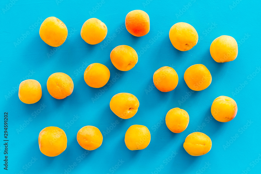 Apricots pattern on blue background top view Apricots pattern on blue background top view