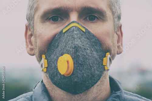 Man wearing a real anti-pollution, anti-smog and viruses face mask photo