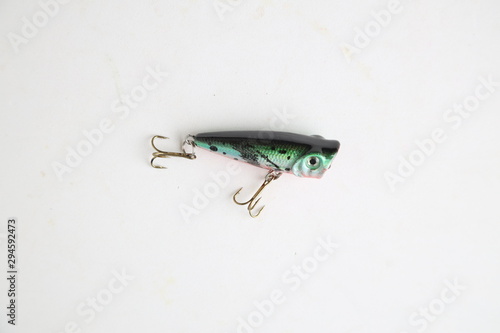 fish-shaped fishing lure on color background