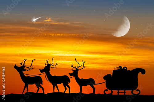 Santa sleigh with reindeer at sunset