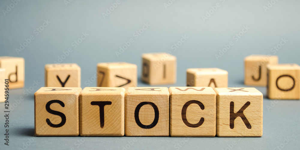 Wooden blocks with the word Stock. Trading on the stock exchange. Investment portfolio. Capital gains. Common and preferred stocks. Market trading and pricing. Share price determination. Wooden blocks with the word Stock. Trading on the stock exchange. Investment portfolio. Capital gains. Common and preferred stocks. Market trading and pricing. Share price determination.