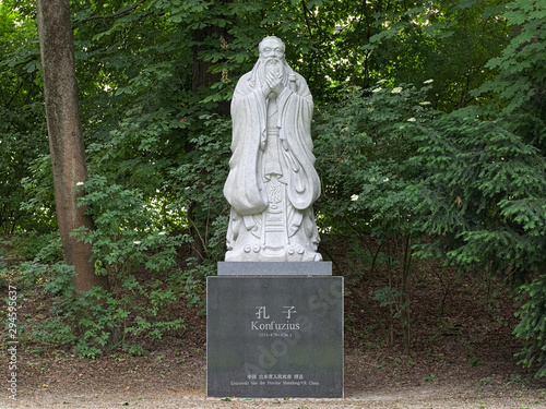 Confucius statue at Dichtergarten (Garden of Poets) in Munich, Germany. Chinese and German inscriptions on the pedestal are read: Gift from Shandong province of the People's Republic of China. photo