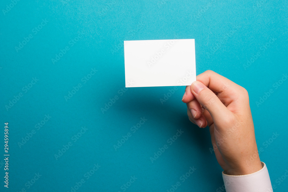 Hand holding business card blank on abstract background Hand holding business card blank on abstract background