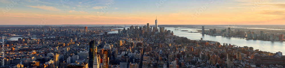 Aerial panoramic view of New York City at Sunset . Brooklyn (left), Midtown and Lower Manhattan (center) with Jersey City (right). USA