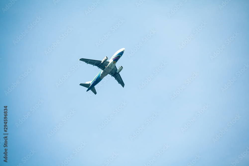 the airplane passenger is flying through the blue sky the airplane passenger is flying through the blue sky