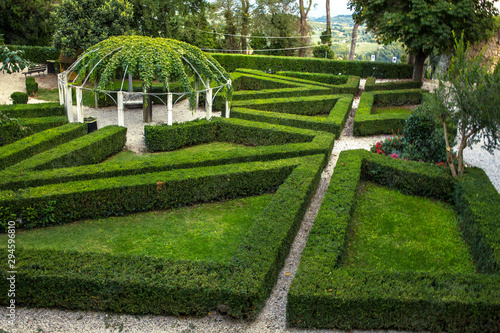 Detail of a small labyrinth built in a garden with hedges.
