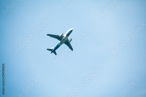 the airplane passenger is flying through the blue sky