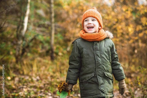 boy in orange hat and scarf walking