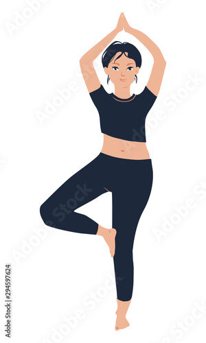 Slim girl staying in the tree pose and training yoga