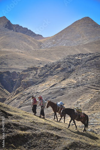 Horsemen in traditional Quechua dress following trails through the Andes. Ausungate trail  Cusco  Peru