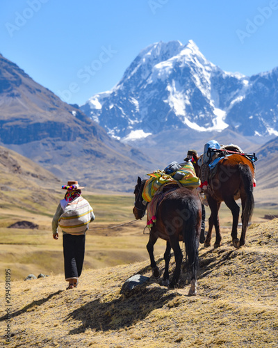 Horsemen in traditional Quechua dress following trails through the Andes. Ausungate trail, Cusco, Peru
