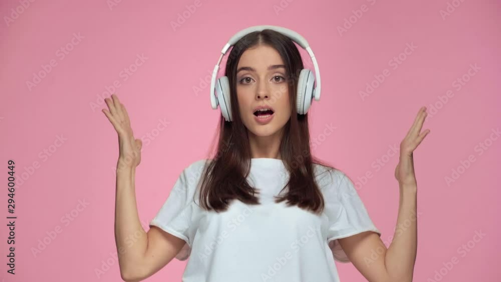 happy girl singing and dancing isolated on pink happy girl singing and dancing isolated on pink