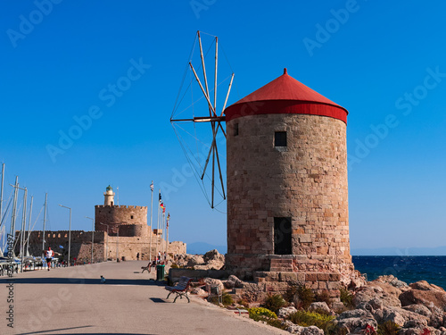 The symbol of Rhodes is a windmill in Mandaki Bay and Fort St. Nicholas