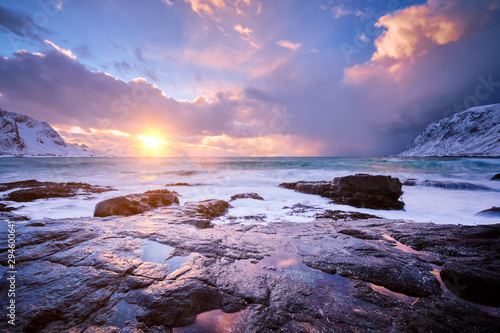 Coast of Norwegian sea on rocky coast in fjord on sunset