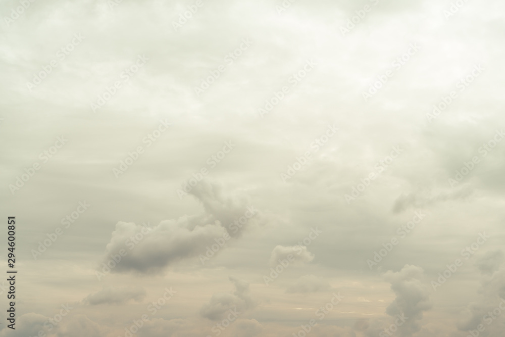 Cloudy autumn sky with clouds of yellow in the bottom bristles of the photo. Gradually lightens to the top of the photo. Horizontal orientation.