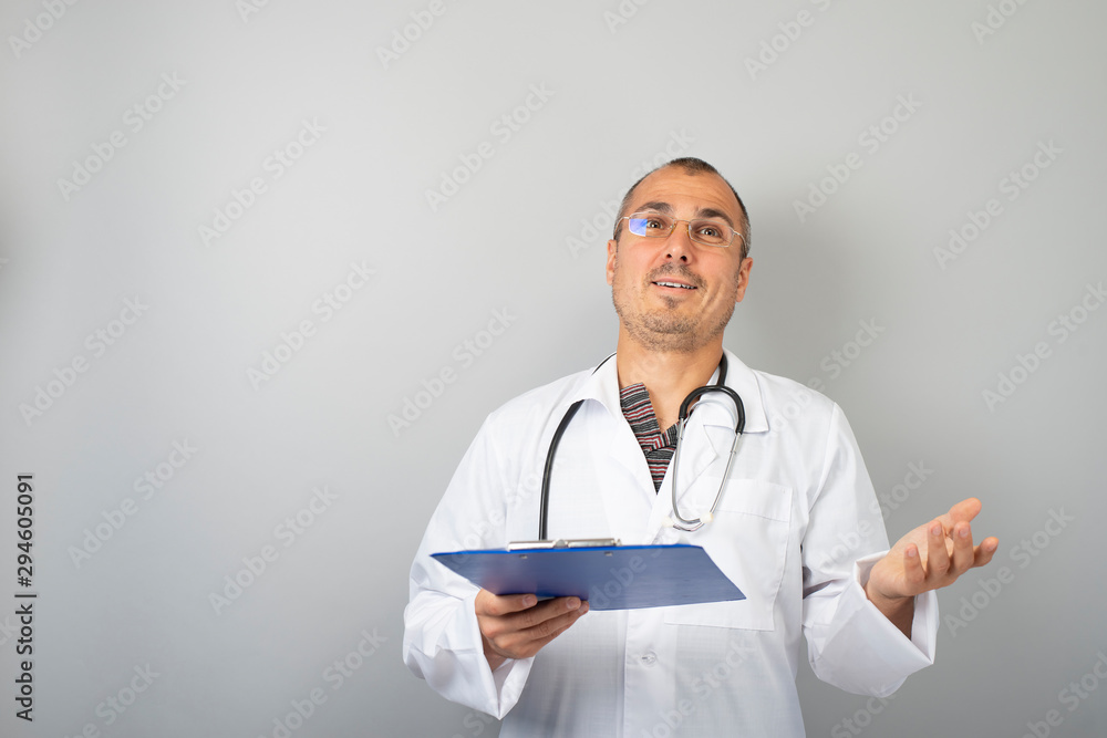 male doctor with a stethoscope around his neck holding documents in his hand male doctor with a stethoscope around his neck holding documents in his hand