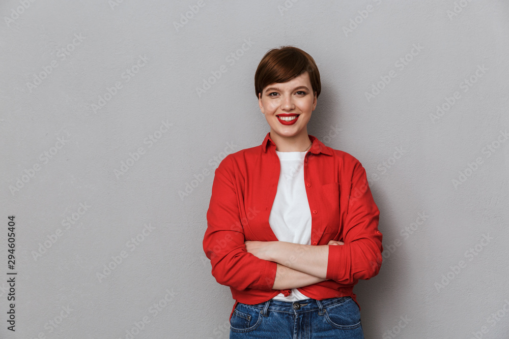 Image of lovely woman wearing casual clothes smiling at camera Image of lovely woman wearing casual clothes smiling at camera