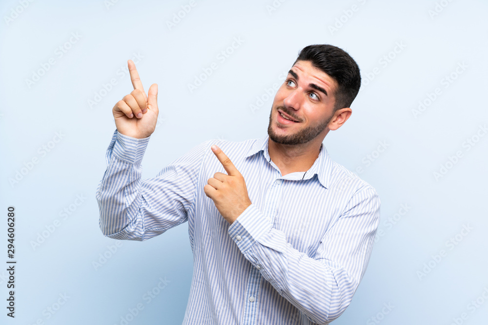 Caucasian handsome man over isolated blue background pointing with the index finger a great idea Caucasian handsome man over isolated blue background pointing with the index finger a great idea