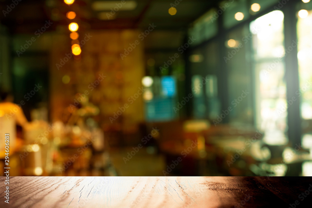 top of wood table with blur retro cafe and light from window interior background