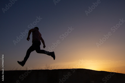 silhouette of man running at sunrise