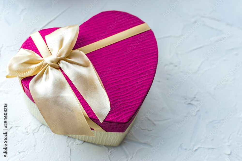 Gift in a box in the shape of a pink heart with a bow on a white background. Romantic gift concept. Valentine's Day Gift in a box in the shape of a pink heart with a bow on a white background. Romantic gift concept. Valentine's Day