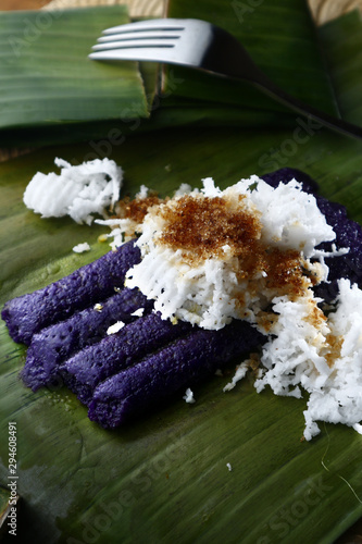 Photo of freshly cooked Filipino delicacy called puto bumbong or ground purple glutenous rice steamed in bamboo tubes photo