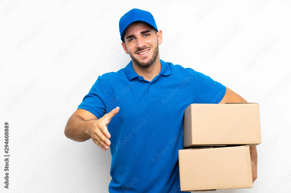 Delivery man over isolated white background handshaking after good deal Delivery man over isolated white background handshaking after good deal