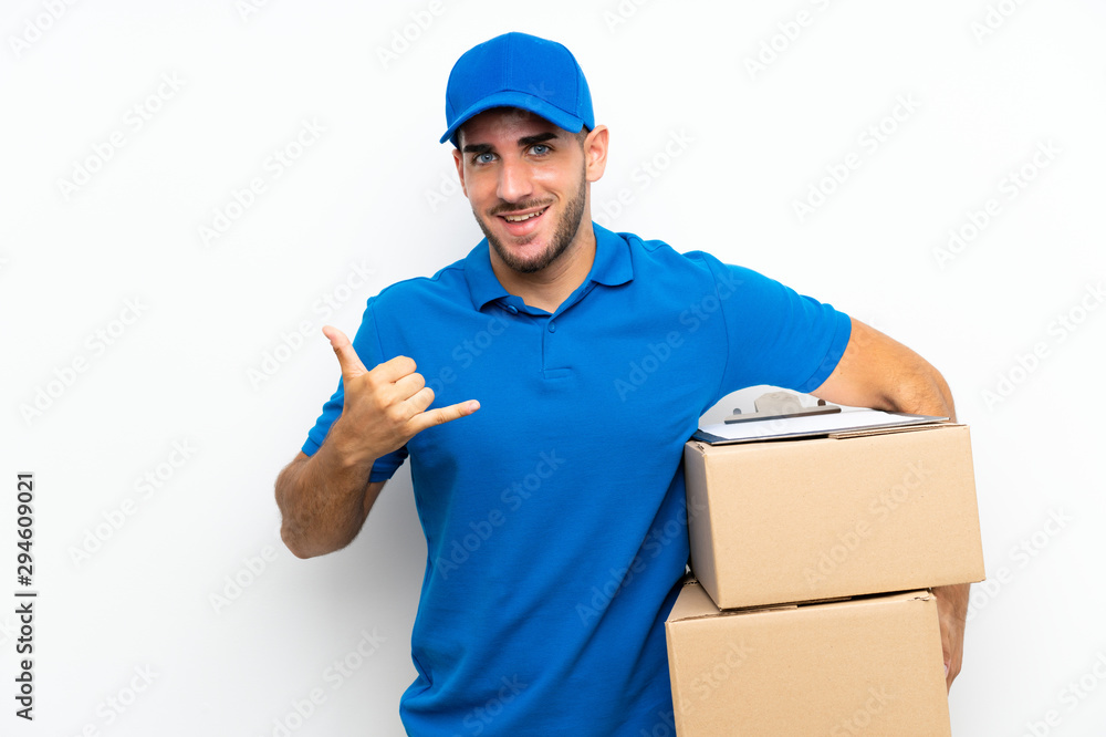 Delivery man over isolated white background making phone gesture Delivery man over isolated white background making phone gesture