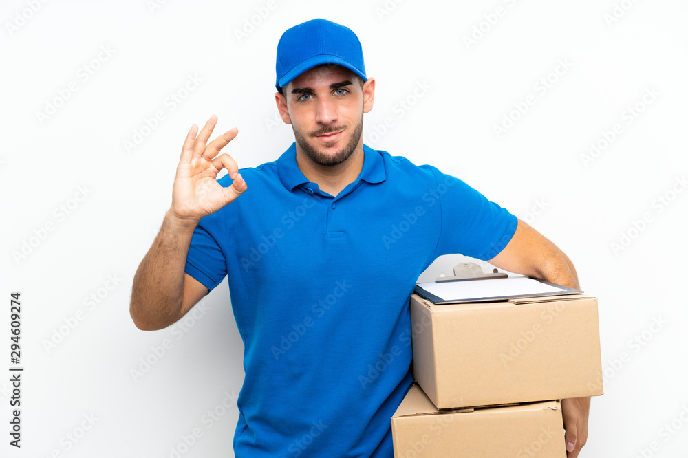 Delivery man over isolated white background showing an ok sign with fingers Delivery man over isolated white background showing an ok sign with fingers