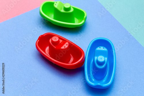 Plastic ships colorful child kid’s education toys pattern background on the bright color background close up. Childhood education play infancy children baby concept