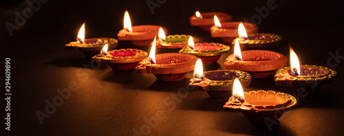 Diwali, Hindu festival of lights celebration. Diya oil lamps against dark background, photo