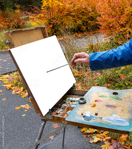 artist with palette and easel