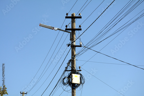 old wooden post with wires and internet junction boxes