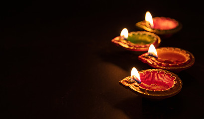 Happy Diwali. Diya colorful oil lamps, dark background