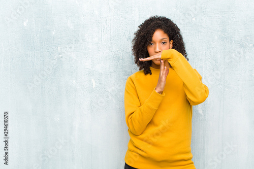 young pretty black woman looking serious, stern, angry and displeased, making time out sign photo