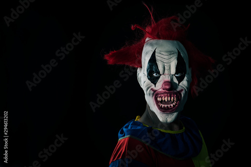 scary evil clown with a bloody mouth photo