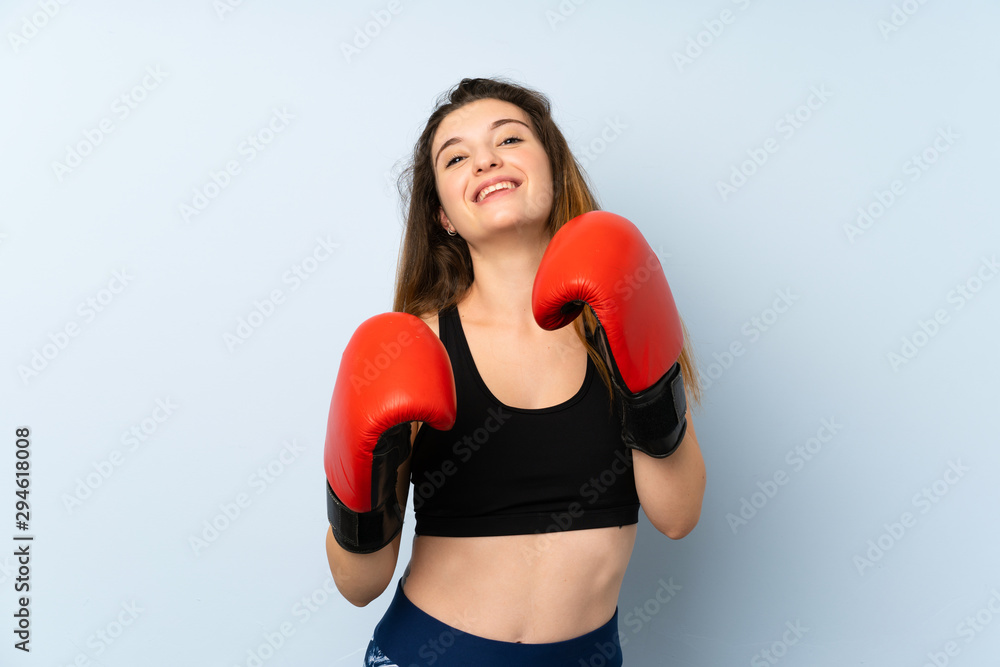 Young brunette girl with boxing gloves over isolated background