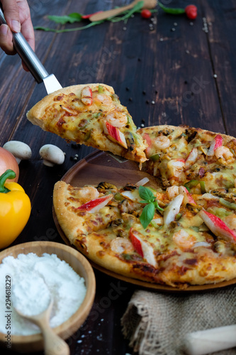 pizza with mushrooms and cheese on wood table