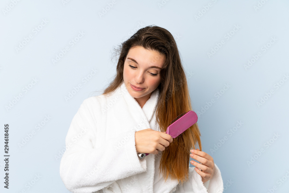 Young woman in a bathrobe with with hair comb. Young woman in a bathrobe with with hair comb.