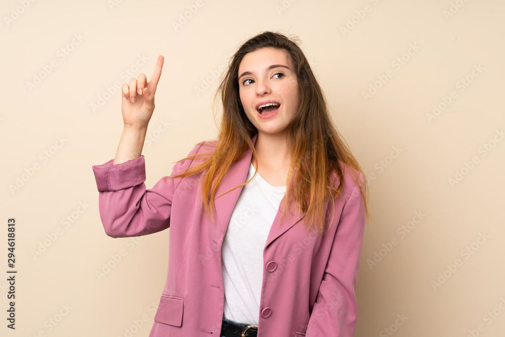 Young brunette girl with blazer over isolated background intending to realizes the solution while lifting a finger up Young brunette girl with blazer over isolated background intending to realizes the solution while lifting a finger up